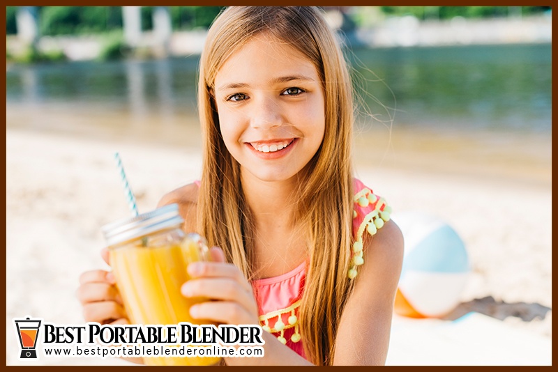 https://bestportableblenderonline.com/wp-content/uploads/2020/07/Girl-enjoying-her-fruit-juice-while-traveling-to-the-beach.jpg